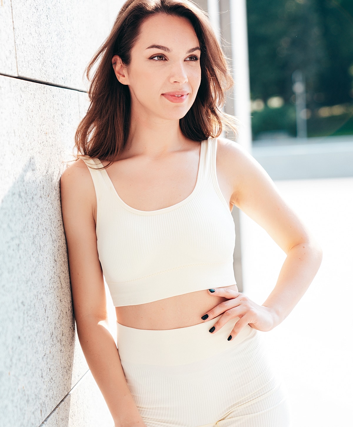Portrait of woman in light activewear outfit.