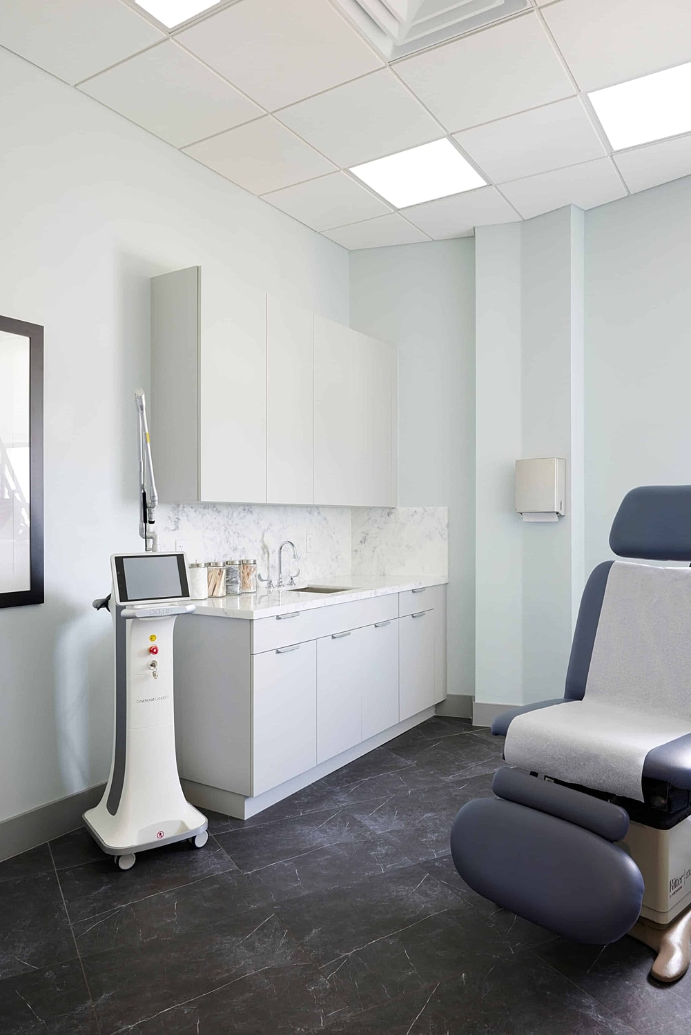 Doctor administering treatment to woman in clinic.