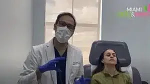 Medical professional consulting patient in clinic setting.