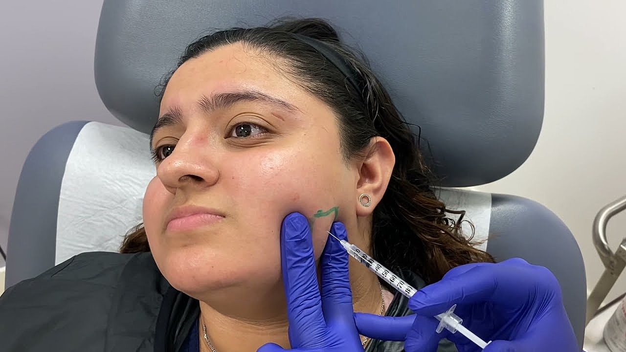 Person receiving cosmetic treatment at clinic.