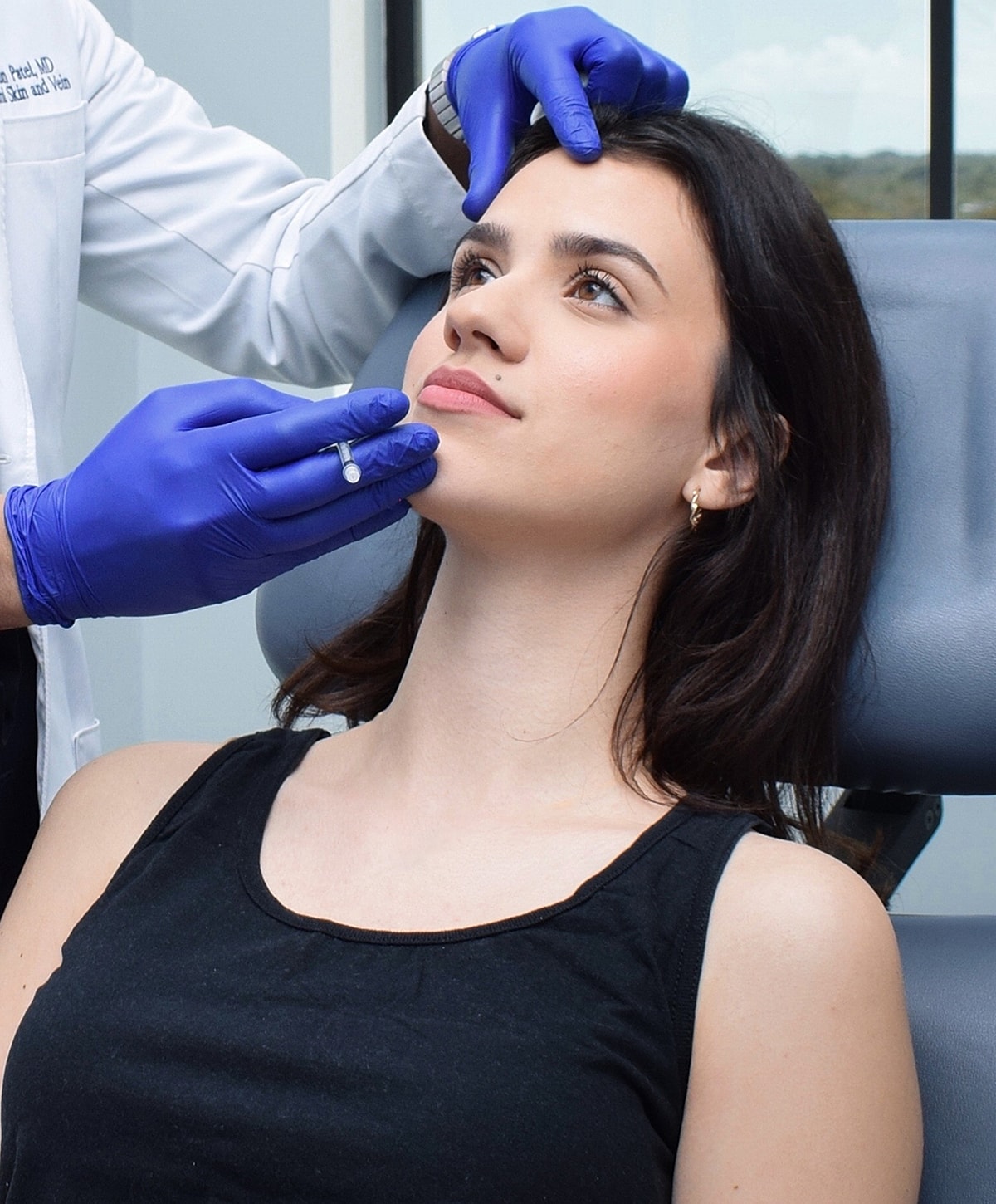 Doctor administering treatment to woman in clinic.