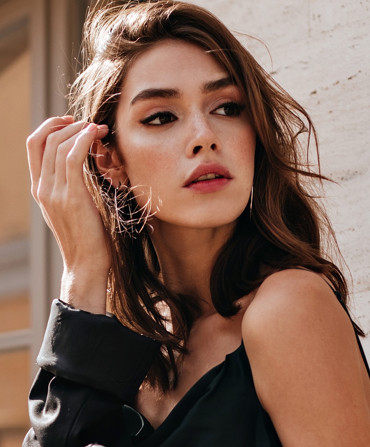 Woman with elegant hairstyle and white blouse.