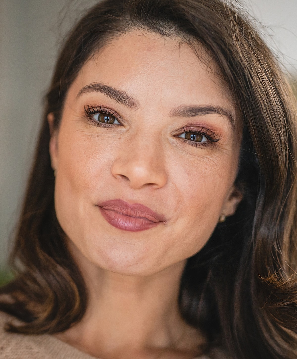 Woman with elegant hairstyle and white blouse.