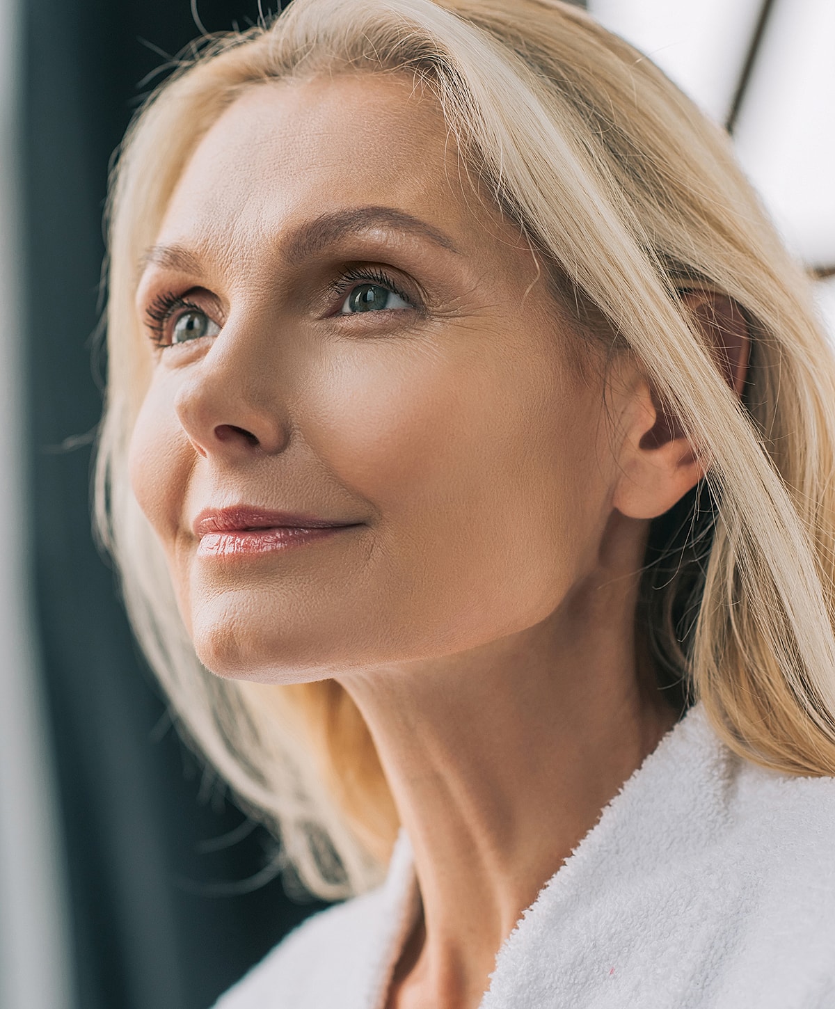 Woman with elegant hairstyle and white blouse.