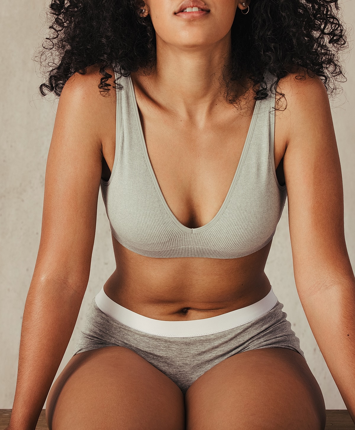 Woman posing in casual loungewear indoors.