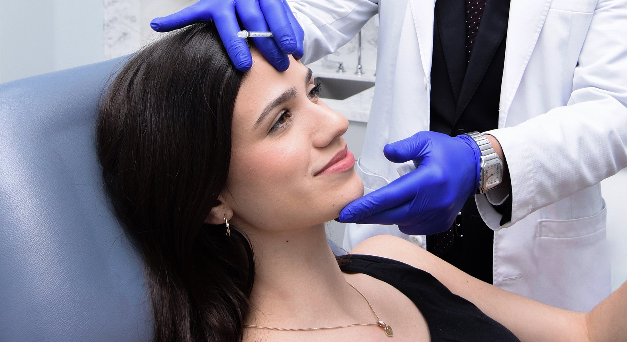 Smiling woman with long hair against white background.