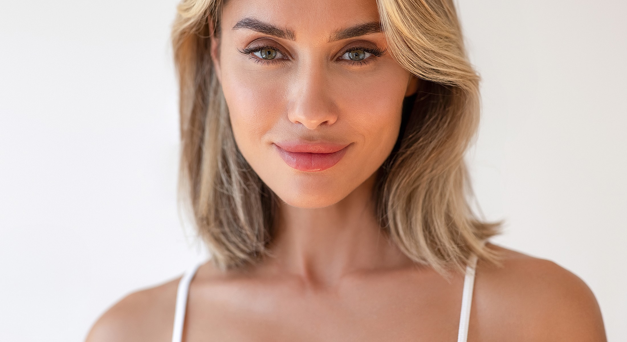 Smiling woman with shoulder-length blonde hair.