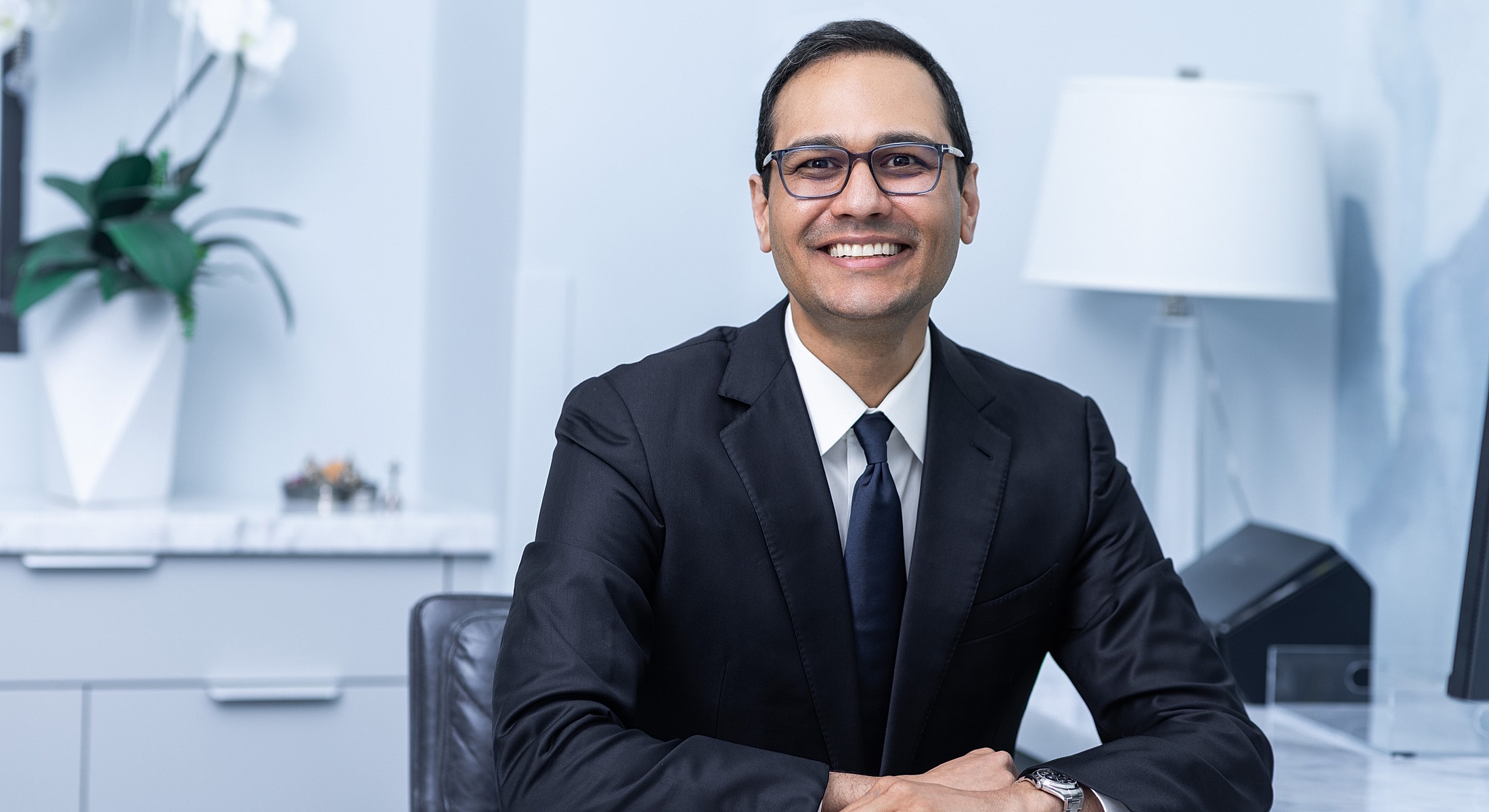 Smiling professional in a modern office setting.