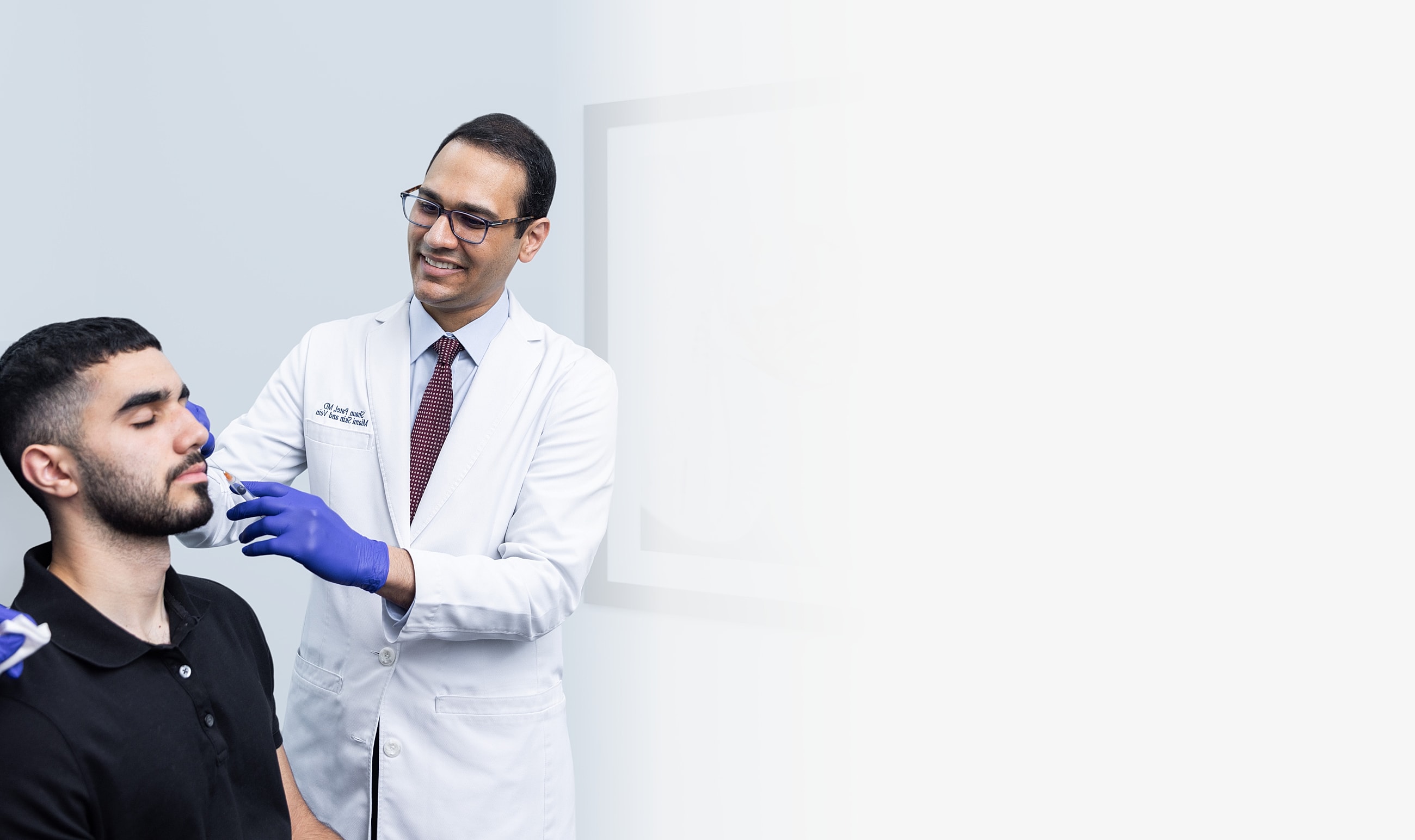 Doctor performing cosmetic treatment on patient.