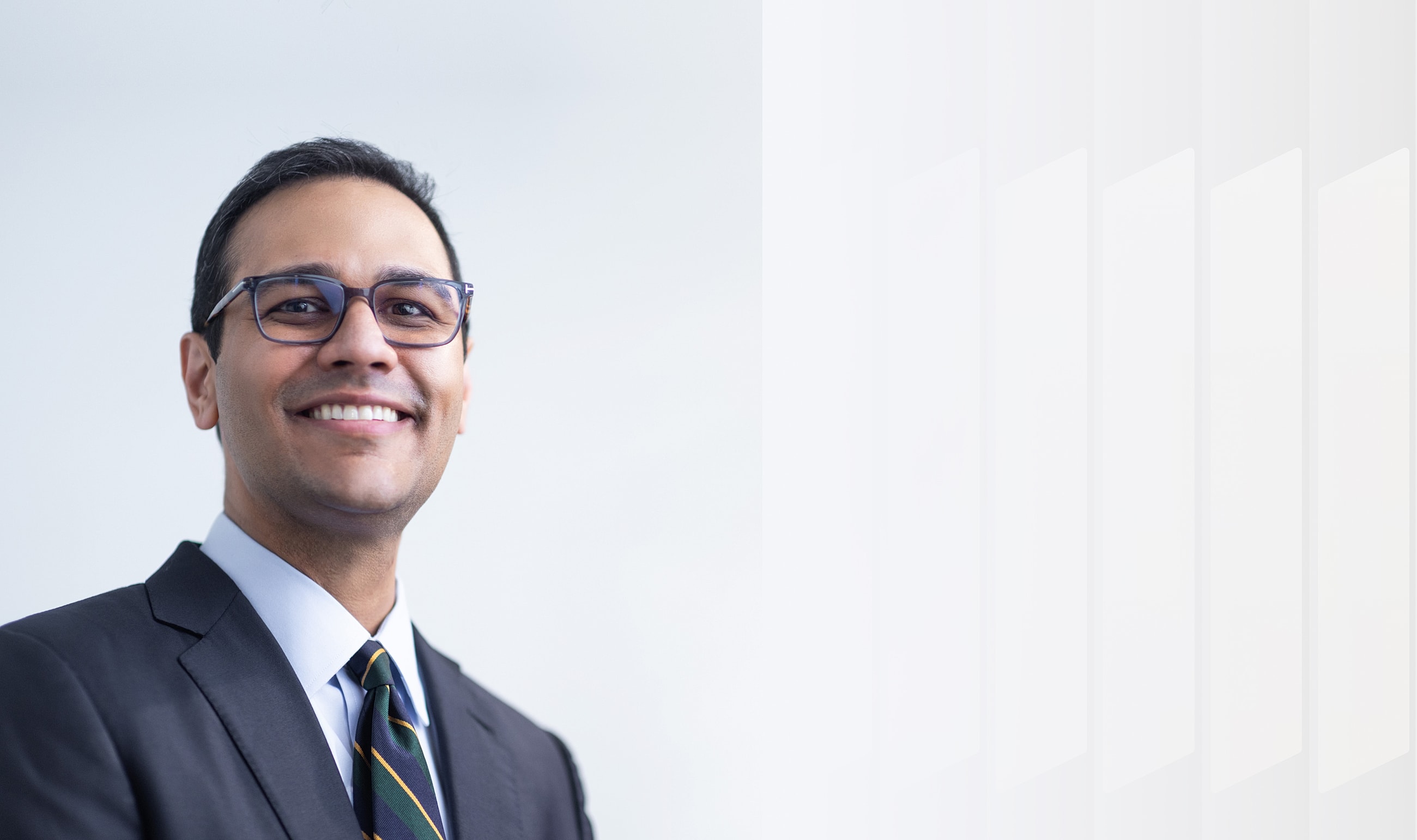 Confident businessman smiling in professional attire.
