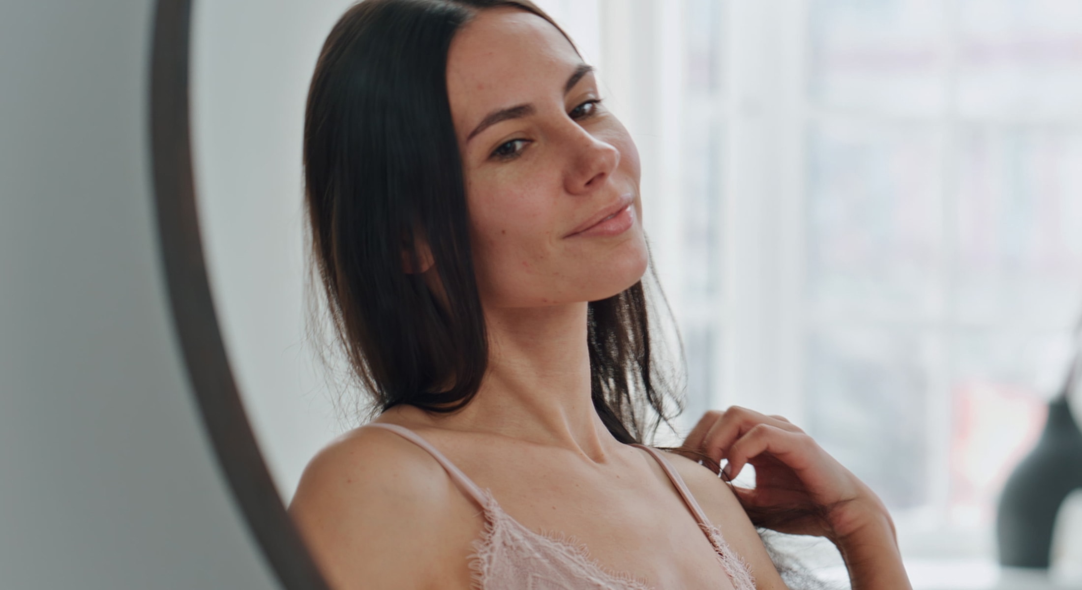 Woman admiring herself in a mirror.