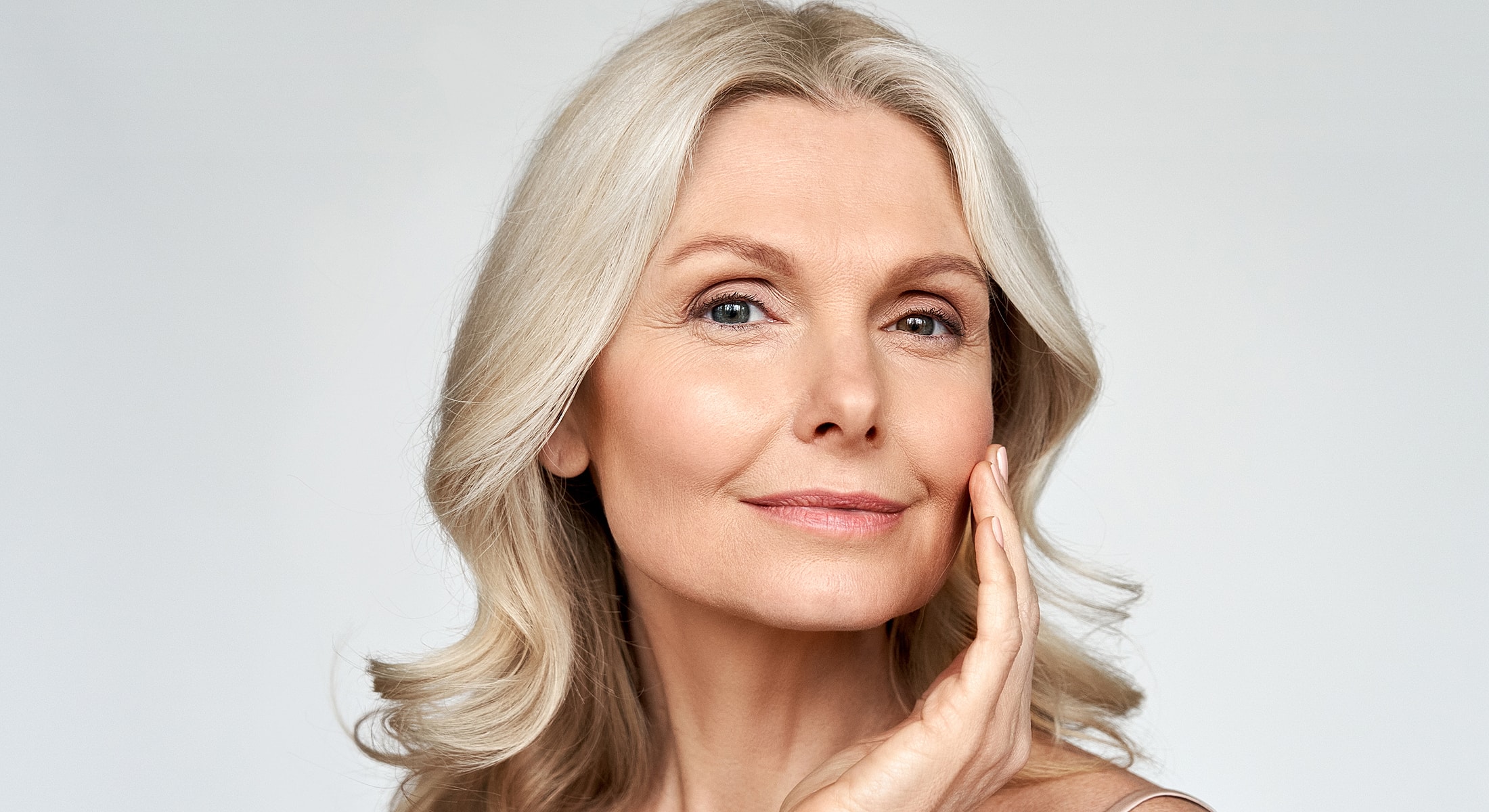 Smiling woman with silver hair and soft expression.