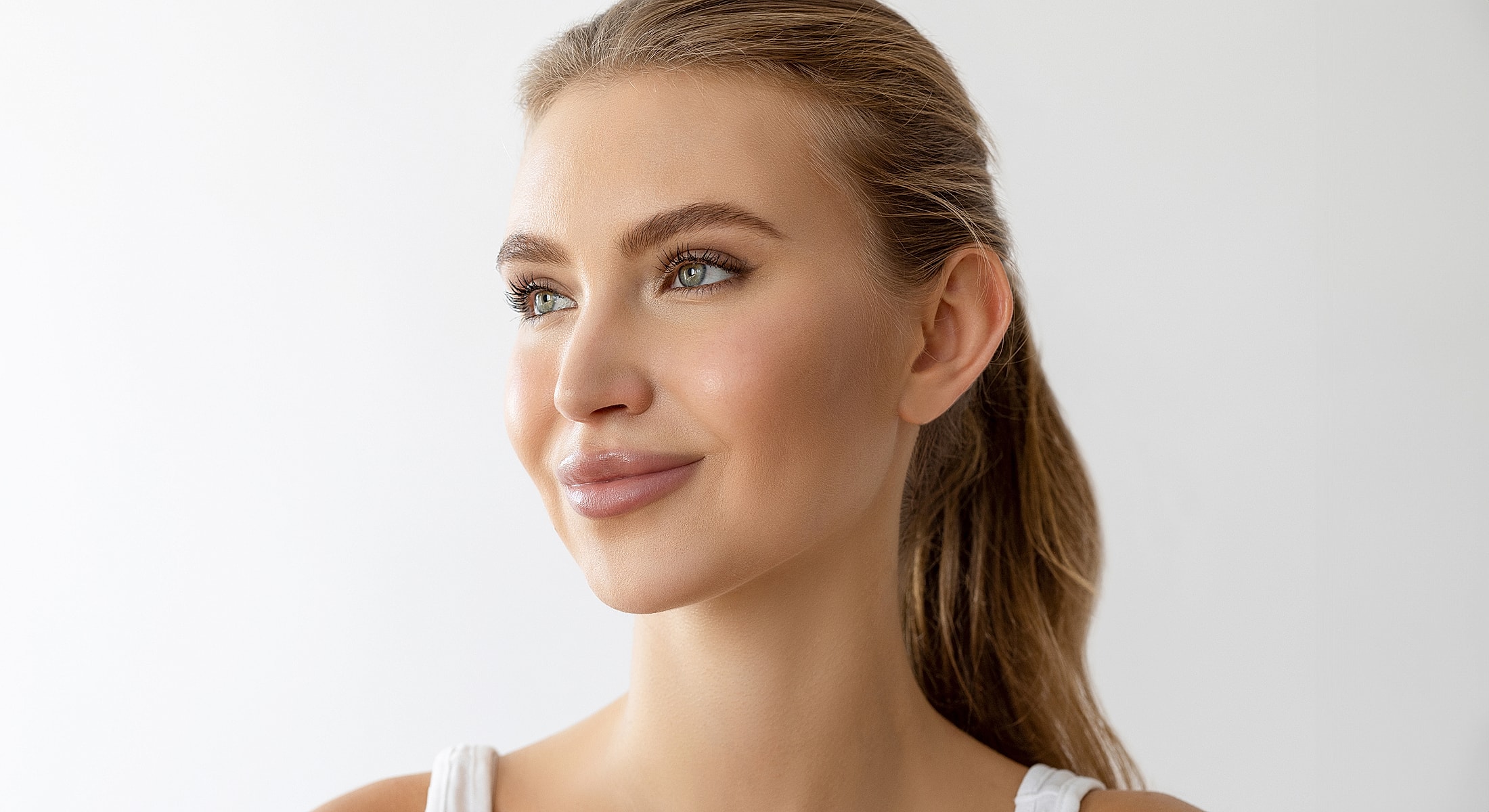 Smiling woman with long hair against white background