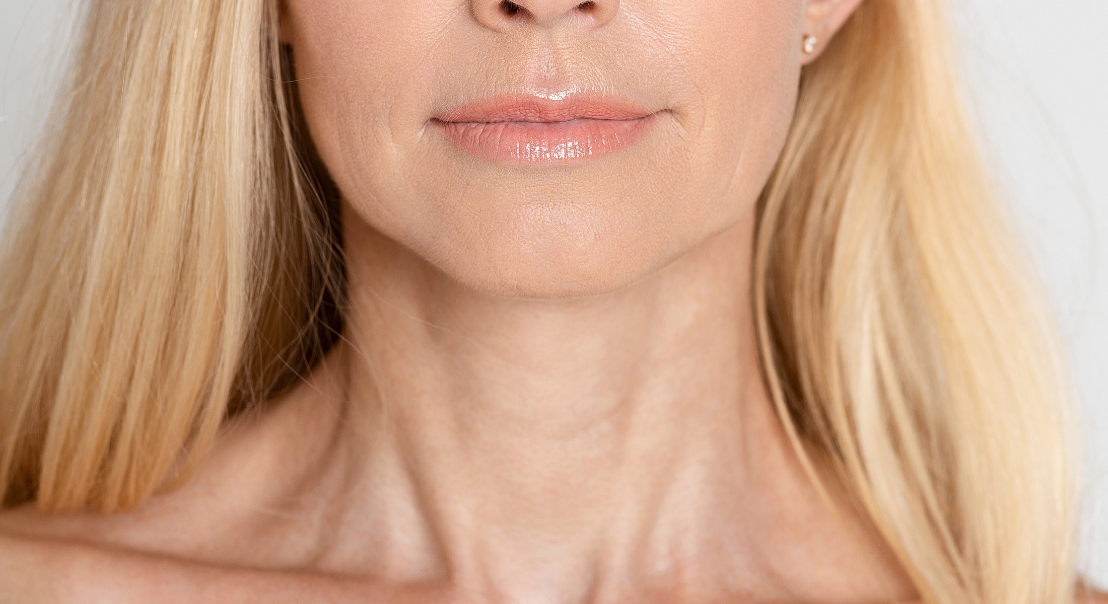 Close-up of woman's lips and neck.